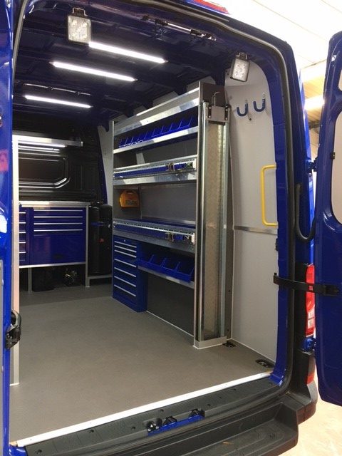 metal shelving units and drawers in van interior