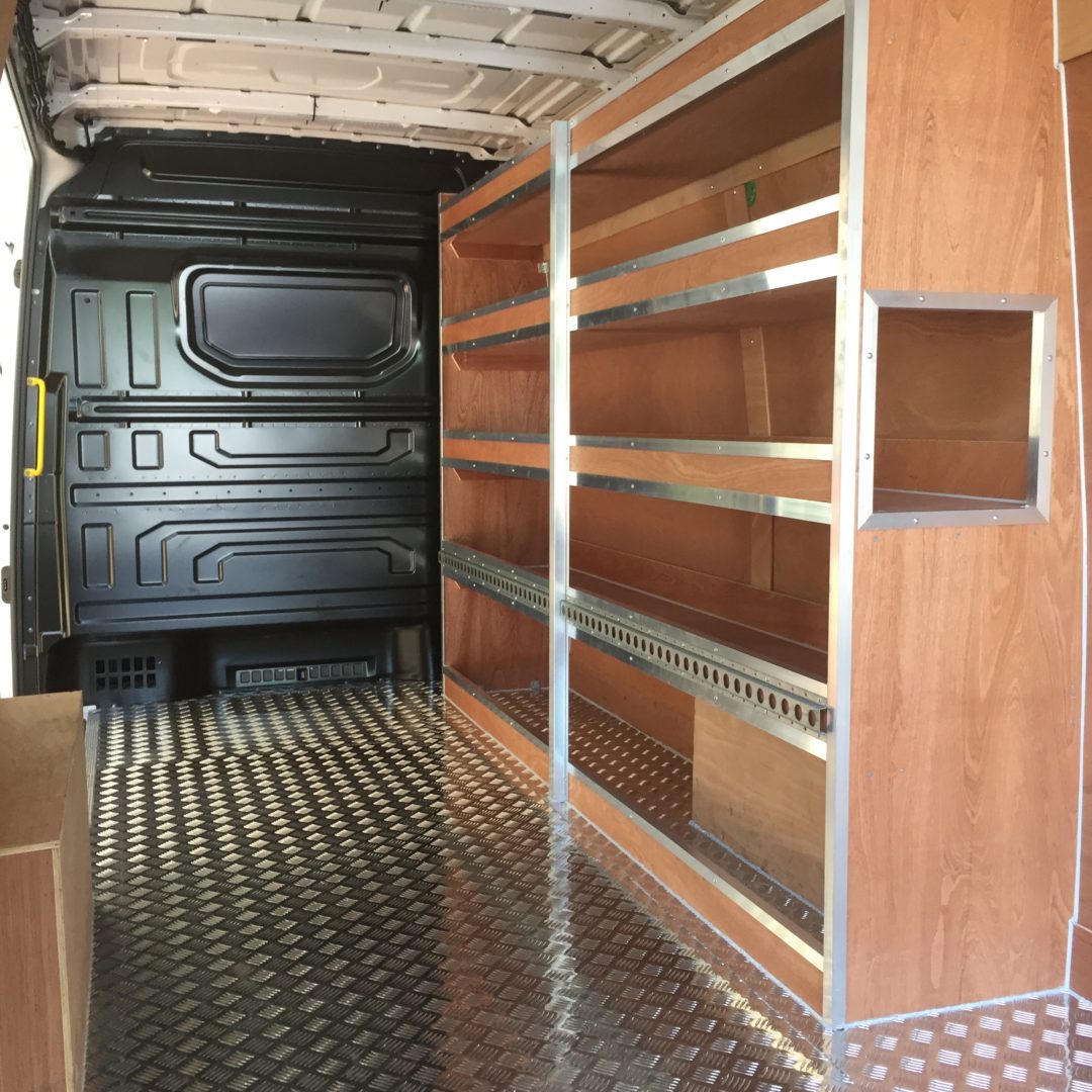 Interior of van with wooden shelving units down either side