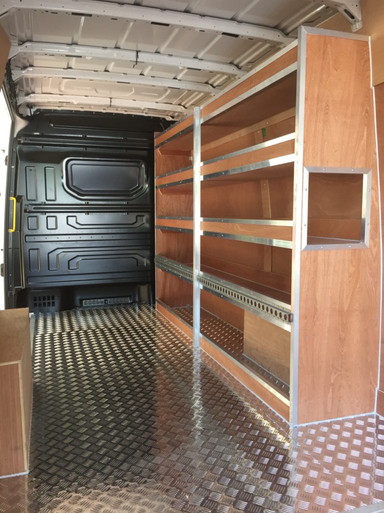 Interior of van with wooden shelving units down either side